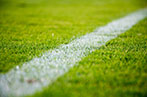 White boundary line on a grassy football field