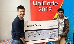 Kaamil Jasani receiving his prize money from Oliver Slot, Head of Marketing and Communications at ShowCode