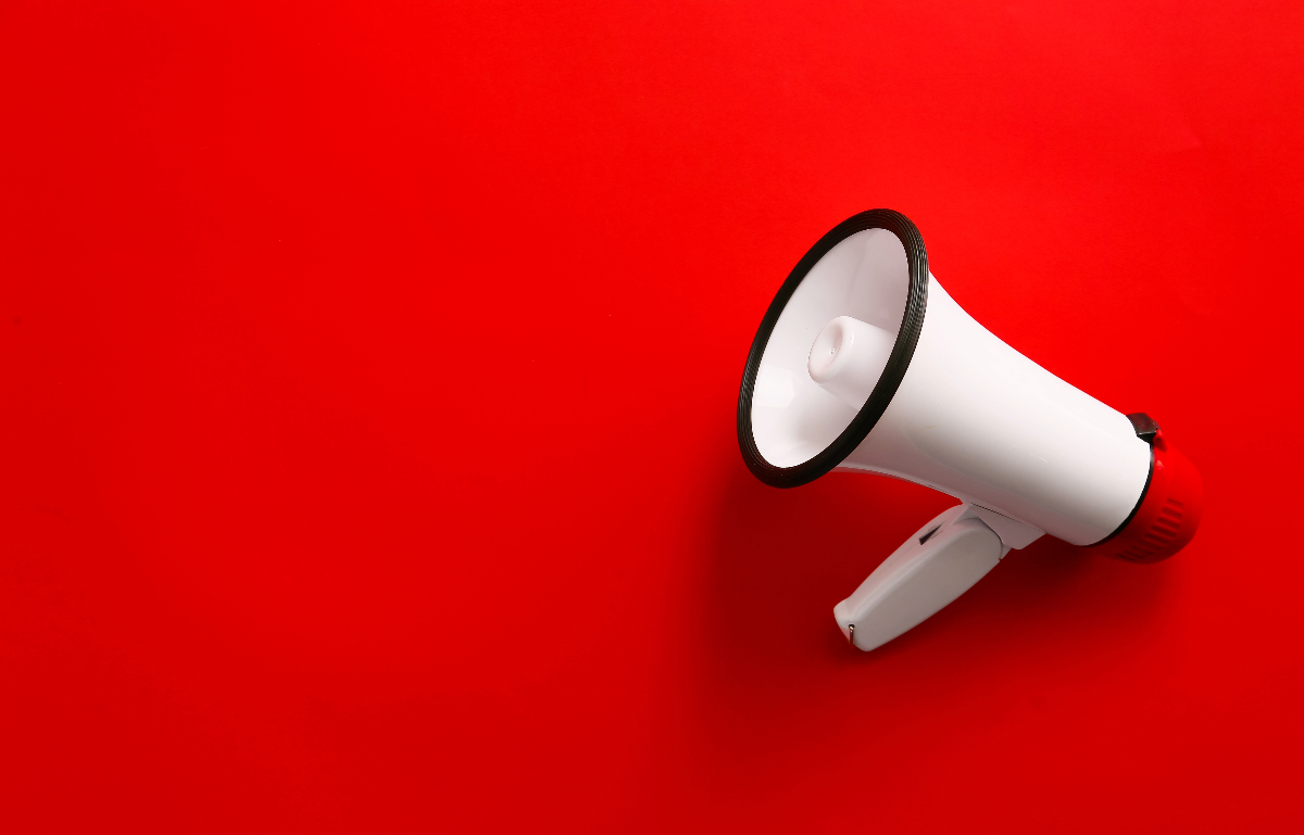 An image of a megaphone against a red background