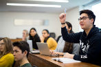 Students in a law lecture at Queen Mary, one student is raising their hand to ask a question