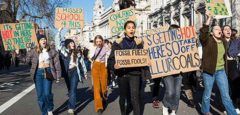 Protestors holding placards at a climate change protest.
