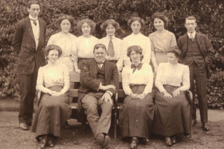 Group of ten students, two male and eight women, and Hilaire Belloc posed for a class photograph
