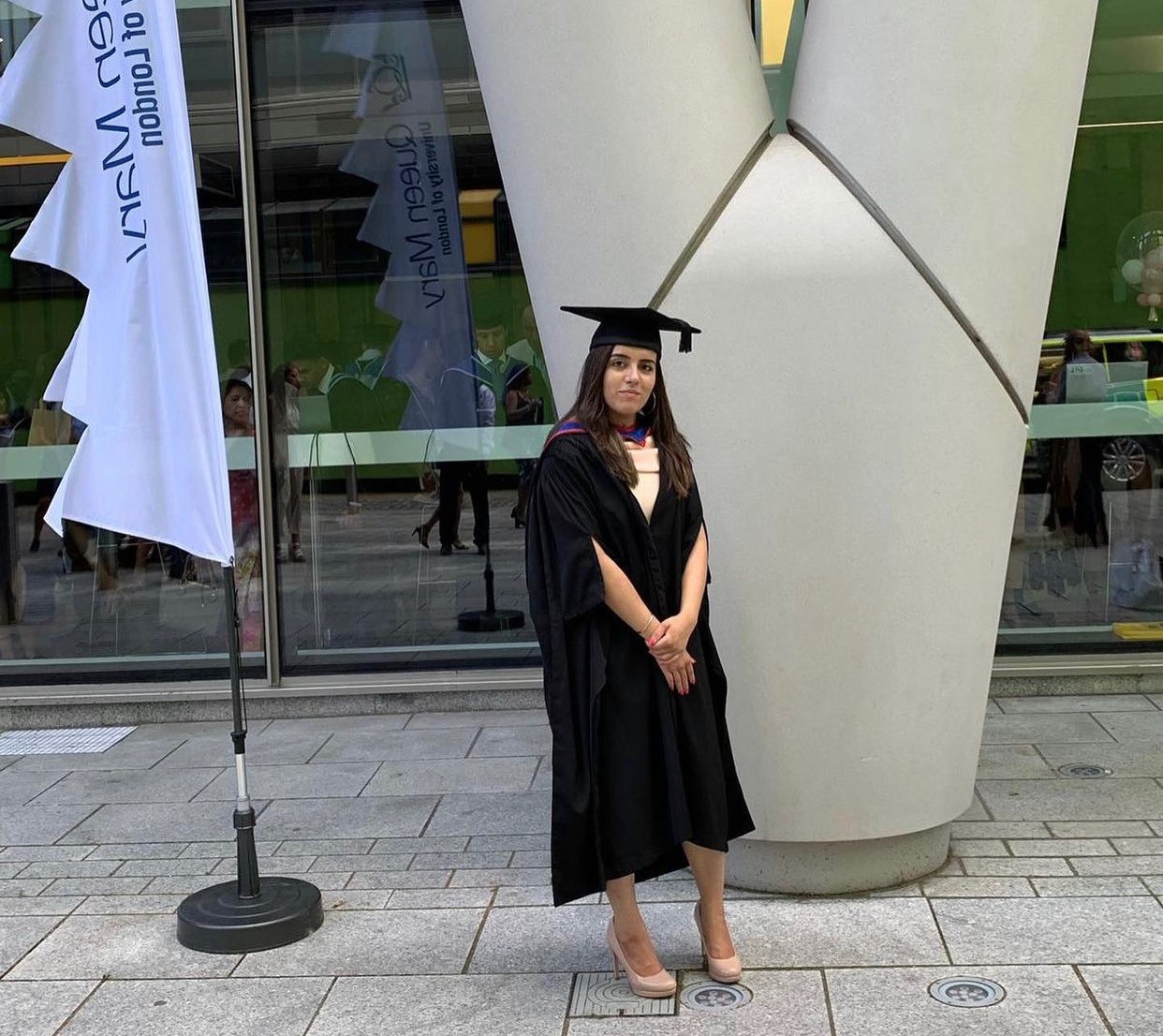 Alumna Amandeep Kaur Gill on her graduation day dressed in her cap and gown.
