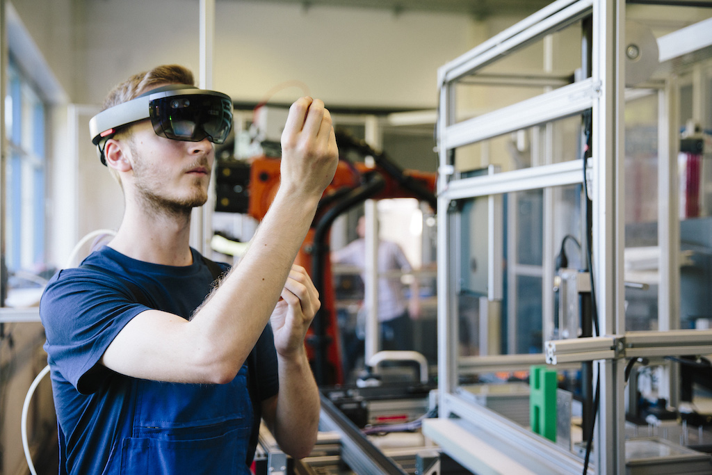 Man looking at technical equipment while wearing goggles