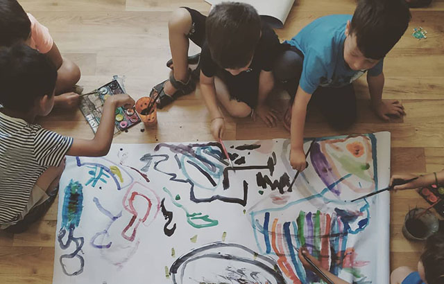 Children painting during the Strengths for the Journey program. Credit: Queen Mary