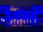 Queen's building lit up blue