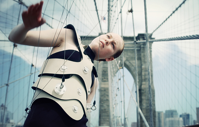 An artist plays the Brooklyn Bridge as part of the Human Harp project 