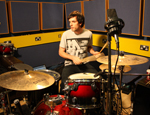 The software allows drummers to set their own pace with pre-programmed music