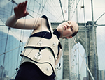 An artist plays the Brooklyn Bridge as part of the Human Harp project 
