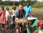 Dr Jonathan Grey, with a common carp caught by local fishermen. Despite having been introduced into Lake Naivasha only 10 years ago, carp now dominates the fishery return, and is indicative of the degraded water quality of the lake.