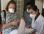 Dr Jess Potter examines a patient's record on an MDR-TB ward in Phnom Penh, Cambodia. Credit: Tom Maguire/RESULTS UK