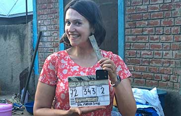 Sophie Harman with a clapper on the film set of PILI