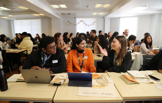 qLegal students having a discussion at an event