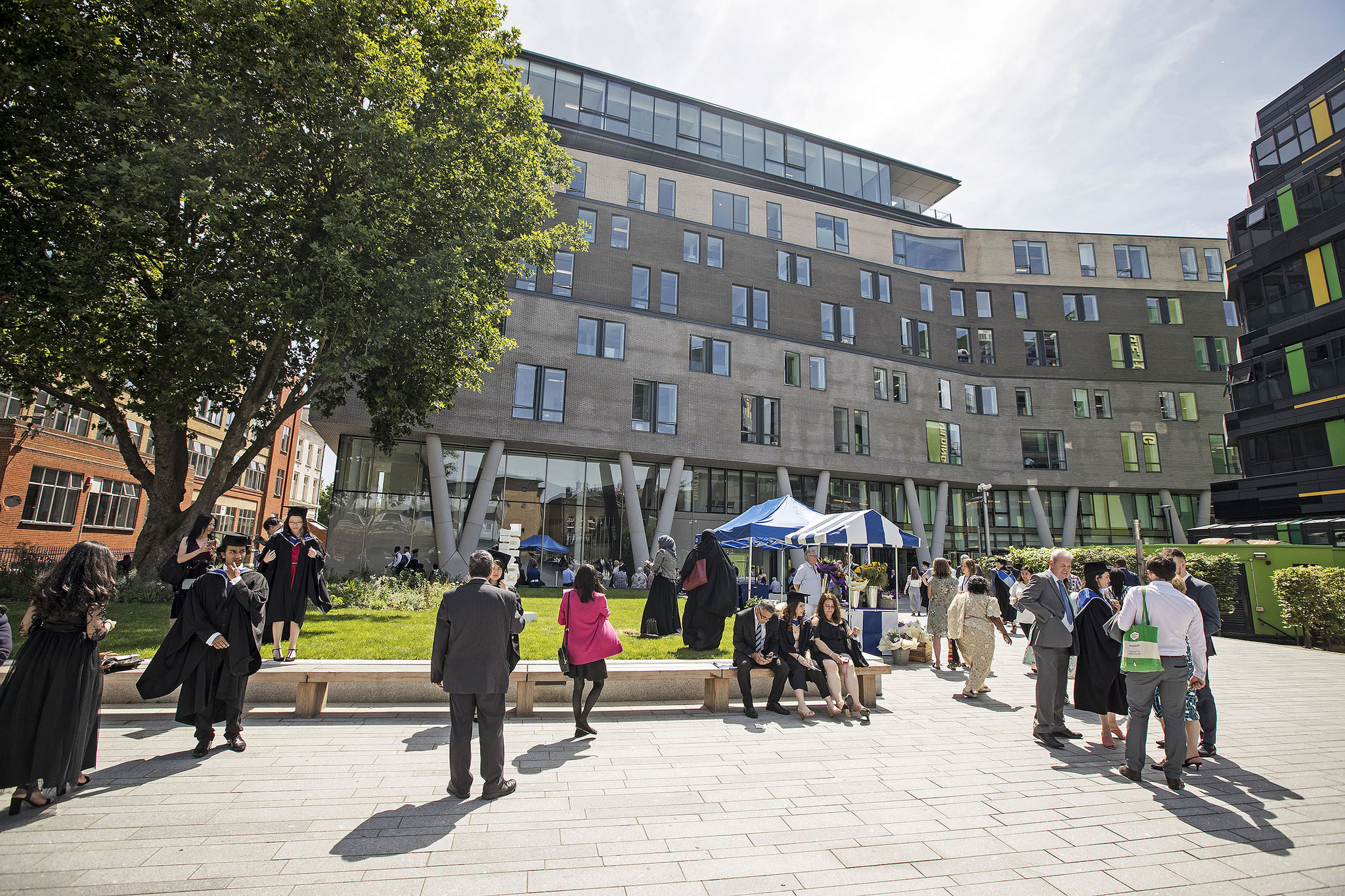 A sunny scene of people walking outside the Graduate Centre, the home of the School of Economics and Finance 