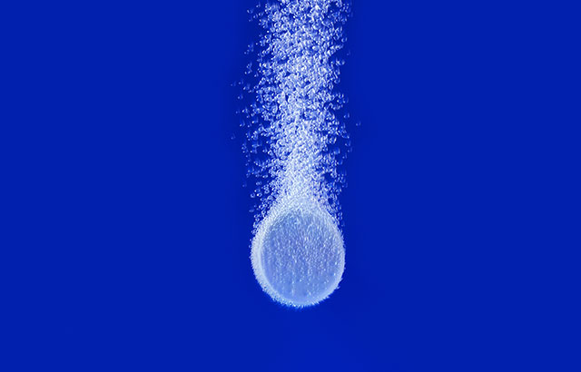 Aspirin tablet disolving in water