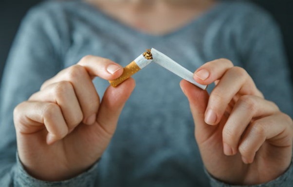 A person breaks a cigarette to show their determination to quit smoking