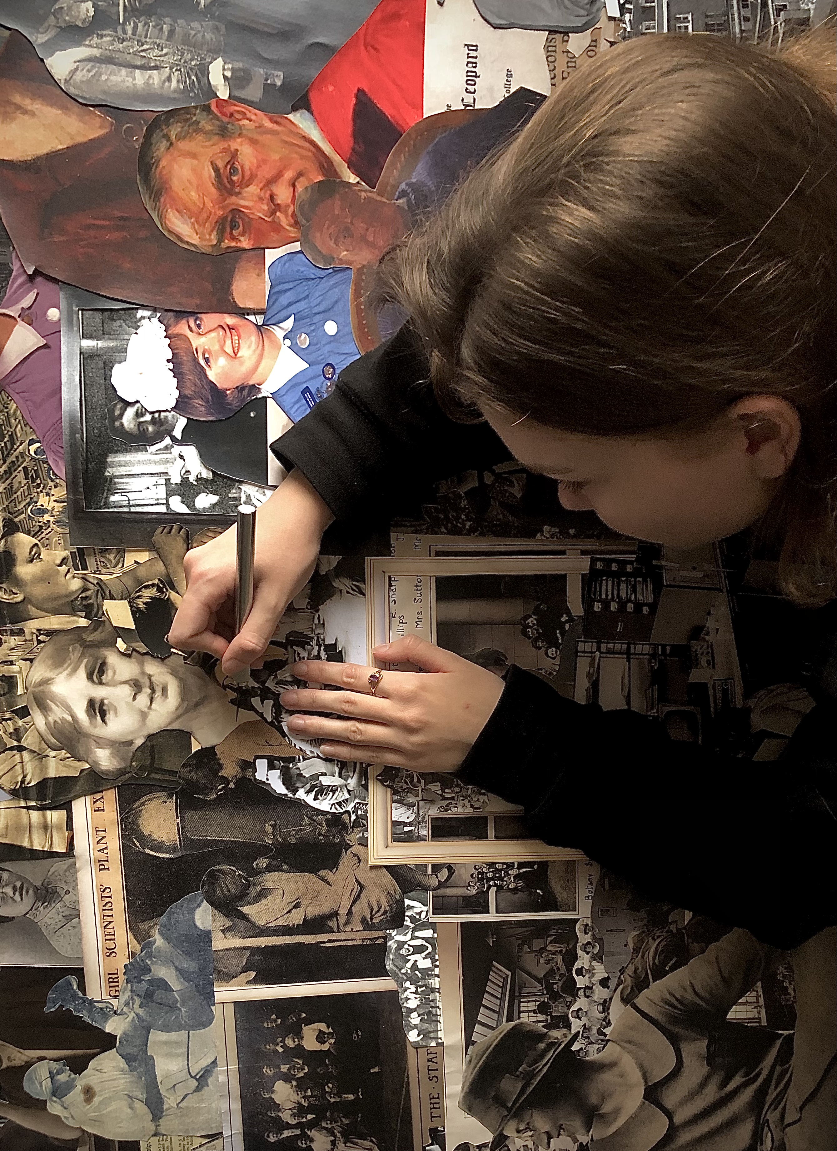 A girl working on an art collage.