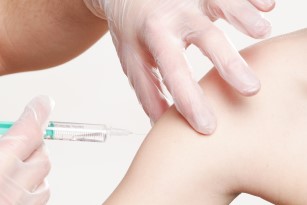 A person receiving a vaccination in the upper arm