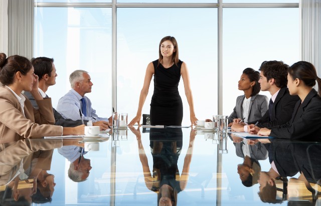 Woman leading meeting in boardroom