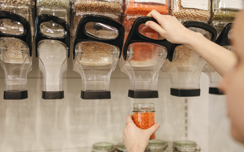 Someone using a zero waste shop to buy lentils