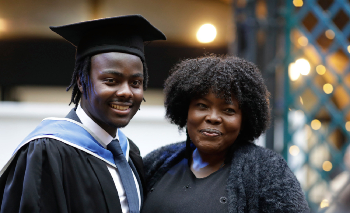 A mother and son smiling at his graduation