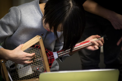 Student playing a electronic guitart