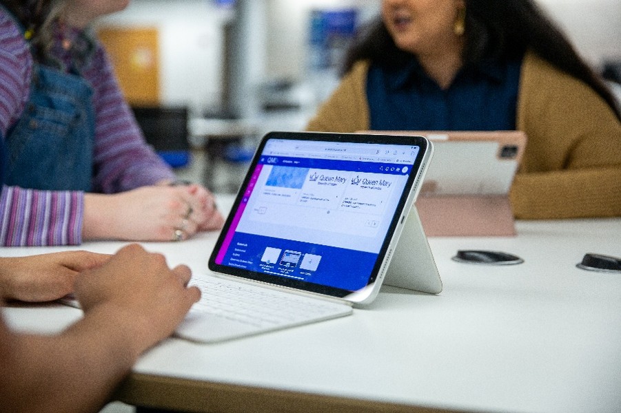 A tablet with keyboard open on a table, with a hand about to type