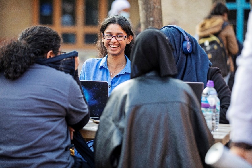 A group of students talking and laughing outside