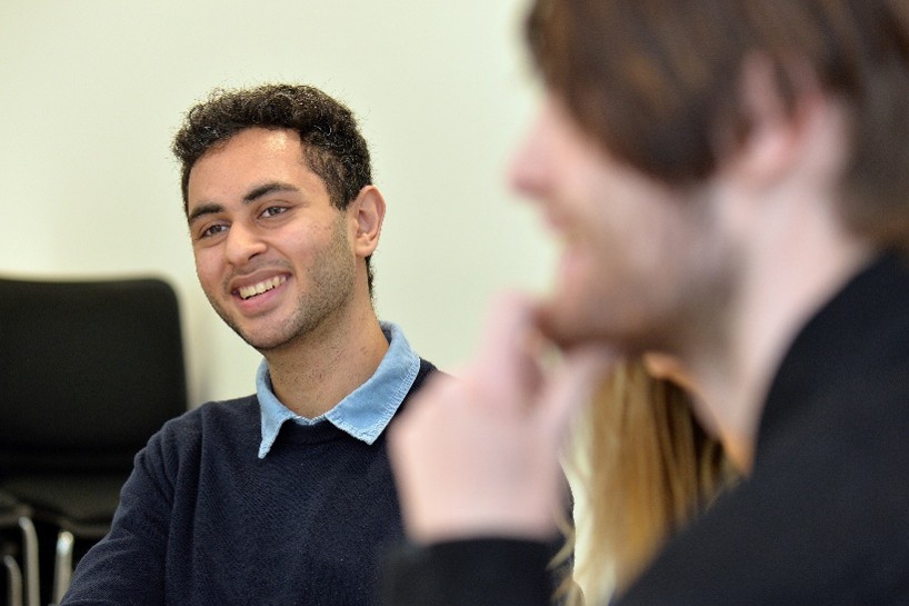 A student smiling in a group of people