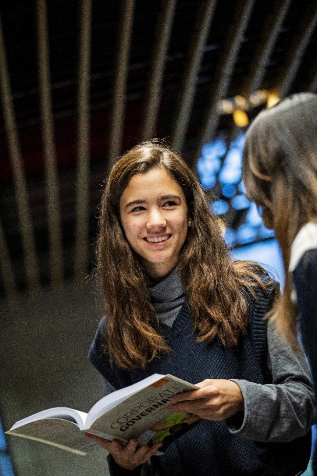 Two students talking inside
