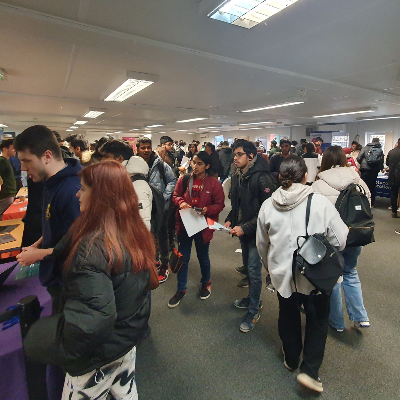 Students talking to employers at a part time jobs fair