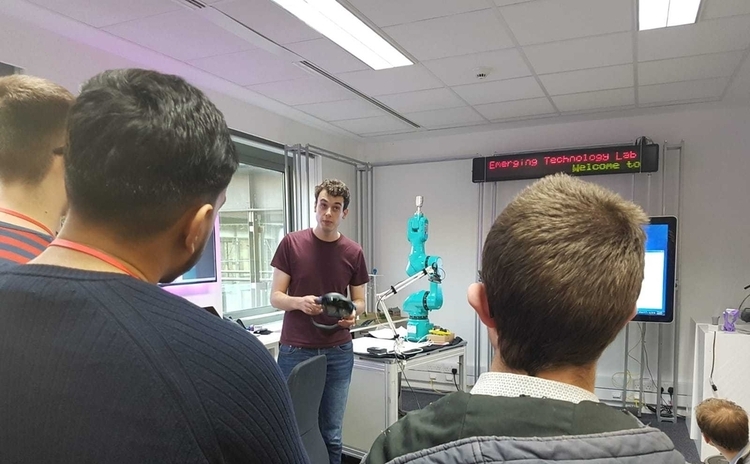 Students listening to a speaker at an office