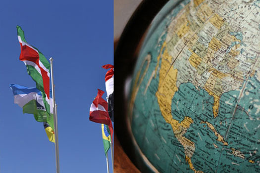 Image of flags blowing in the wind on the left and a globe on the right