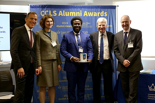 Francis Ben Kaifala holding the Achievement Award with Judging Panel and Lord Kitchin