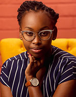 Assunta Ndami in glasses and wearing a striped top