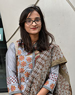 Atia Marzia wearing glasses and a sari outside Queen Mary's Graduate Centre
