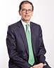 Felipe Cuberos wearing a suit and green tie