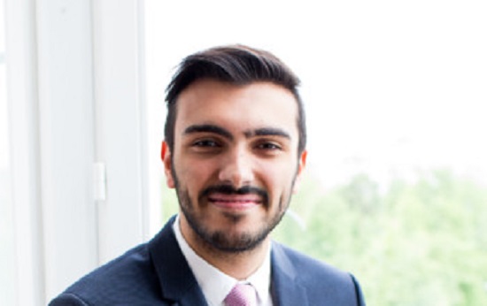 Man with dark hair and beard smiling