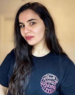 Mary Rizk wearing a t-shirt with the Team DIMA Global logo on it
