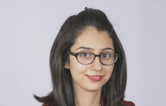 Woman with shoulder length dark hair and glasses