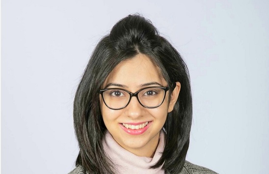 Woman with shoulder length dark hair and glasses