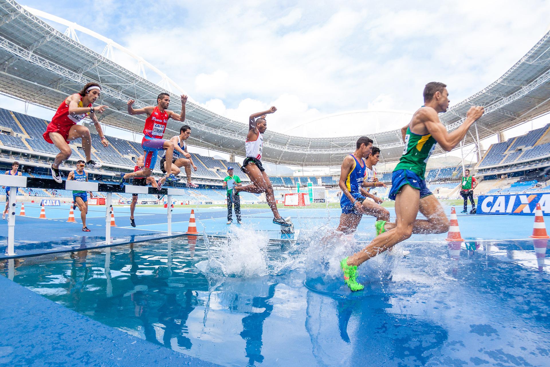 Four athletes running through water