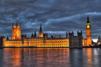 Landscape image of the UK Houses of Parliament at night.
