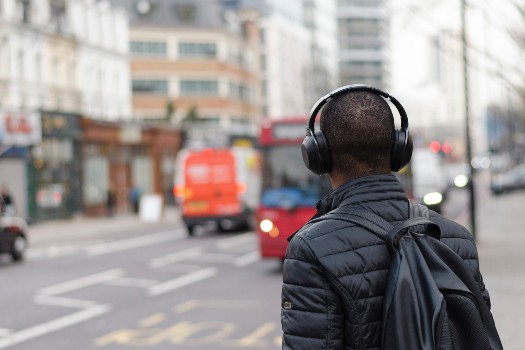 Person wearing headphones crossing the street
