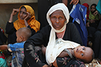 Rohingya refugee woman cradling her baby