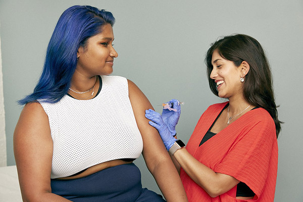 Young woman about to receive a vaccine