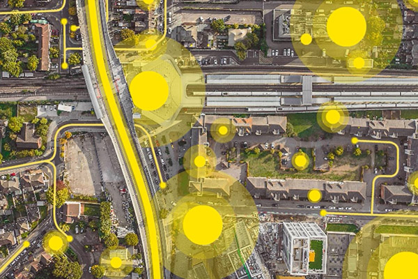 Aerial photograph of an urban landscape with bright yellow dots highlighting locations