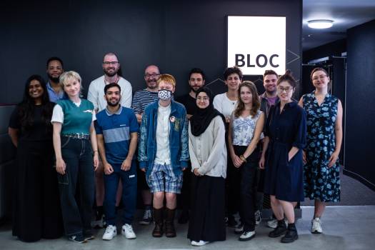 group of students in front of a lit sign for BLOC cinema