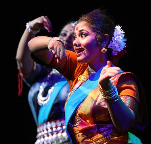 two ladies in saris dance as part of a Bangladeshi theatre festival