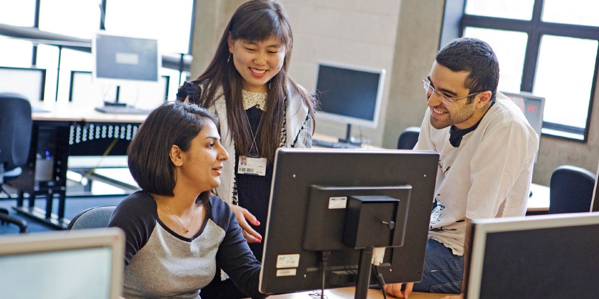 Students looking at computer